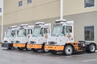 All-electric terminal trucks by Orange EV for efficient cargo handling.